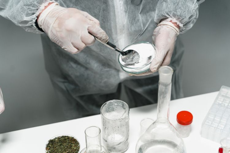A Person Testing Powder in a lab
